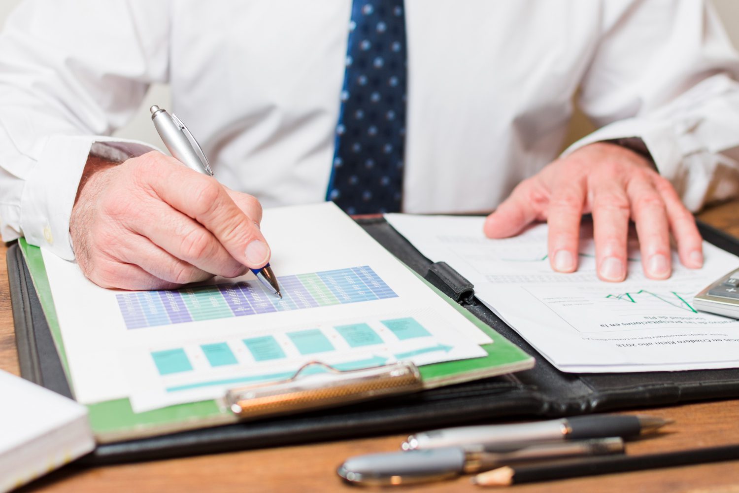 businessman-writing-documents businessman-writing-documents